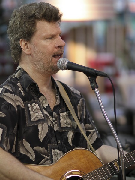 Photo of Mark Desrochers in front of a microphone